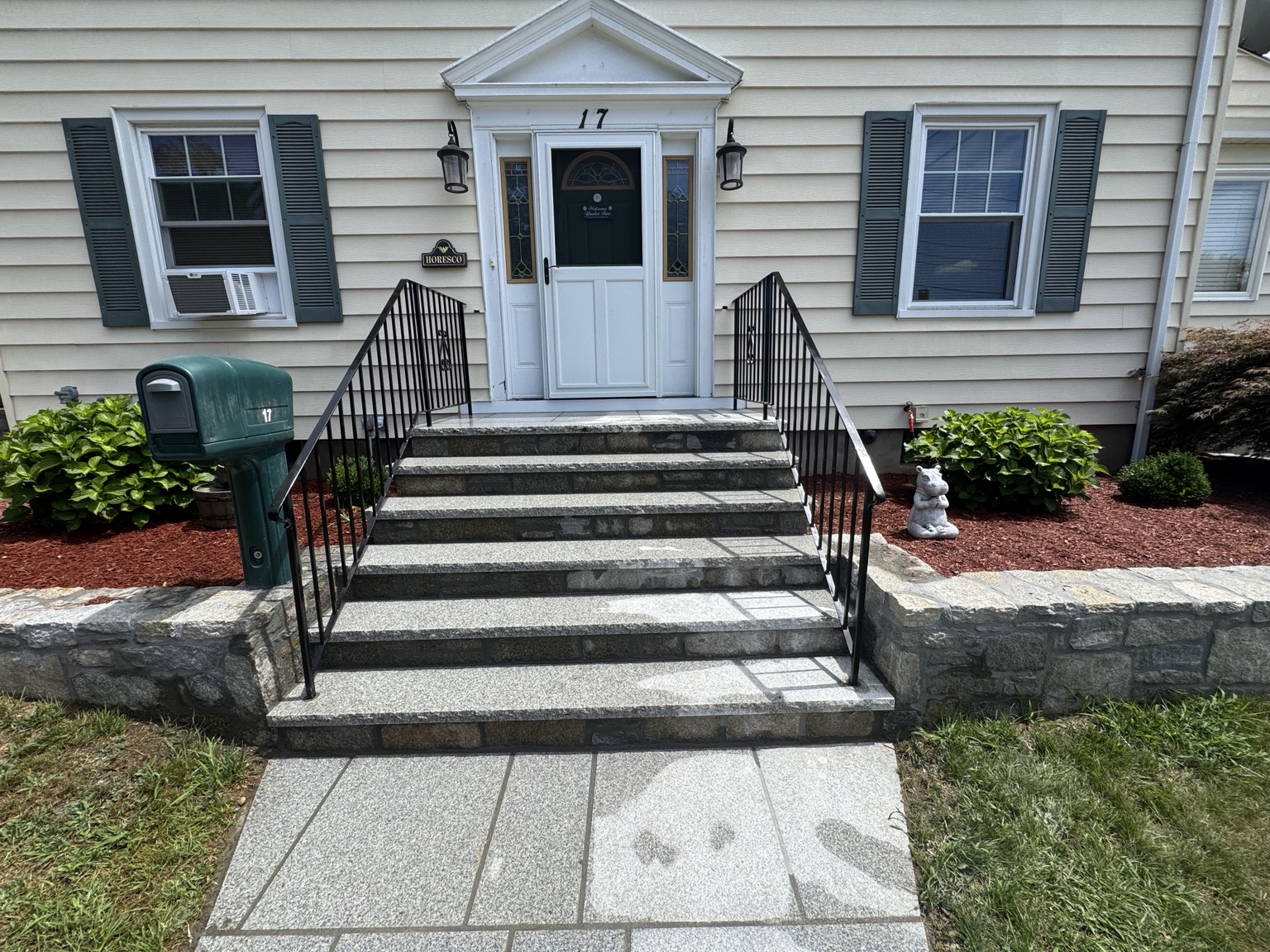 Black exterior stair railings built by Liquid Heat